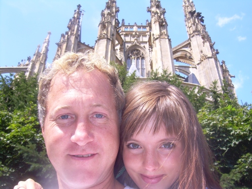 Couple in front of Gothic church, sunny day blue sky